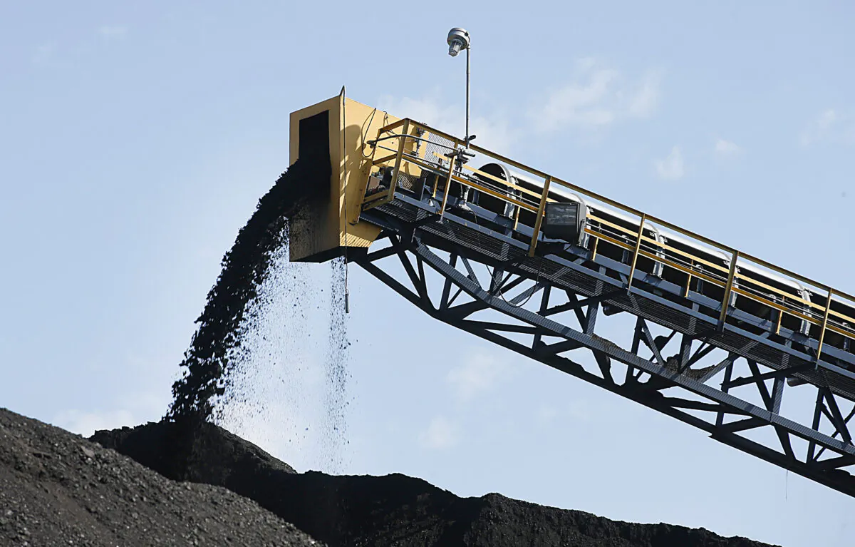 Coal falls off a conveyer belt as it's off loaded from trucks from local coal mines at the Savage Energy Terminal on Aug. 26, 2016, in Price, Utah. (George Frey/Getty Images