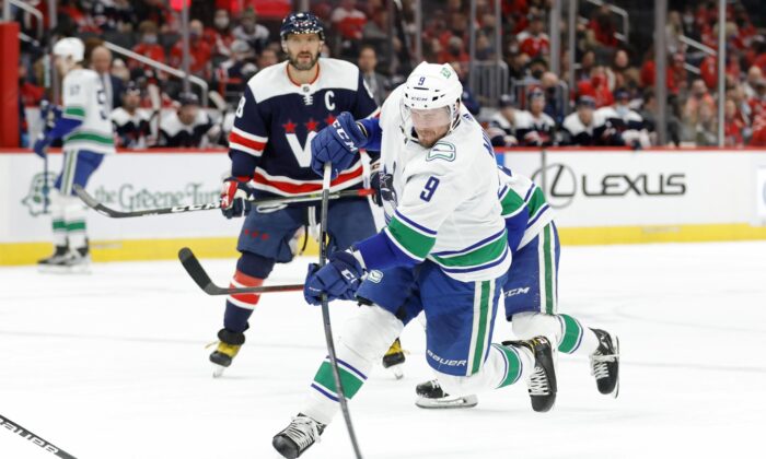 Vancouver Canucks center J.T. Miller (9) shoots the puck against the Washington Capitals during the second period at Capital One Arena, in Wash., on Jan. 16, 2022. (Geoff Burke/USA TODAY Sports via Field Level Media)