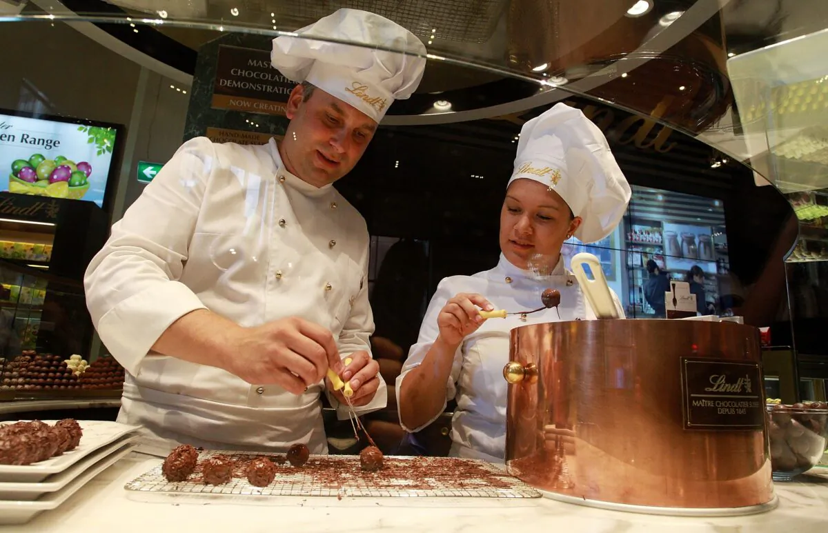 Staff members prepare chocolate at the Lindt Cafe in Martin Place, Sydney, on March 20, 2015. (Lisa Maree Williams/Getty Images)