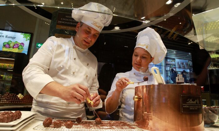 Staff members prepare chocolate at the Lindt Cafe in Martin Place, Sydney, on March 20, 2015. (Lisa Maree Williams/Getty Images)
