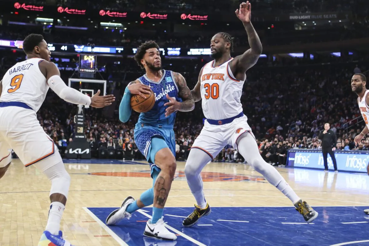 Charlotte Hornets forward Miles Bridges (0) drives past New York Knicks guard RJ Barrett (9) and forward Julius Randle (30) in the second quarter at Madison Square Garden in New York, on Jan. 17, 2022. (Wendell Cruz/USA TODAY Sports via Field Level Media)