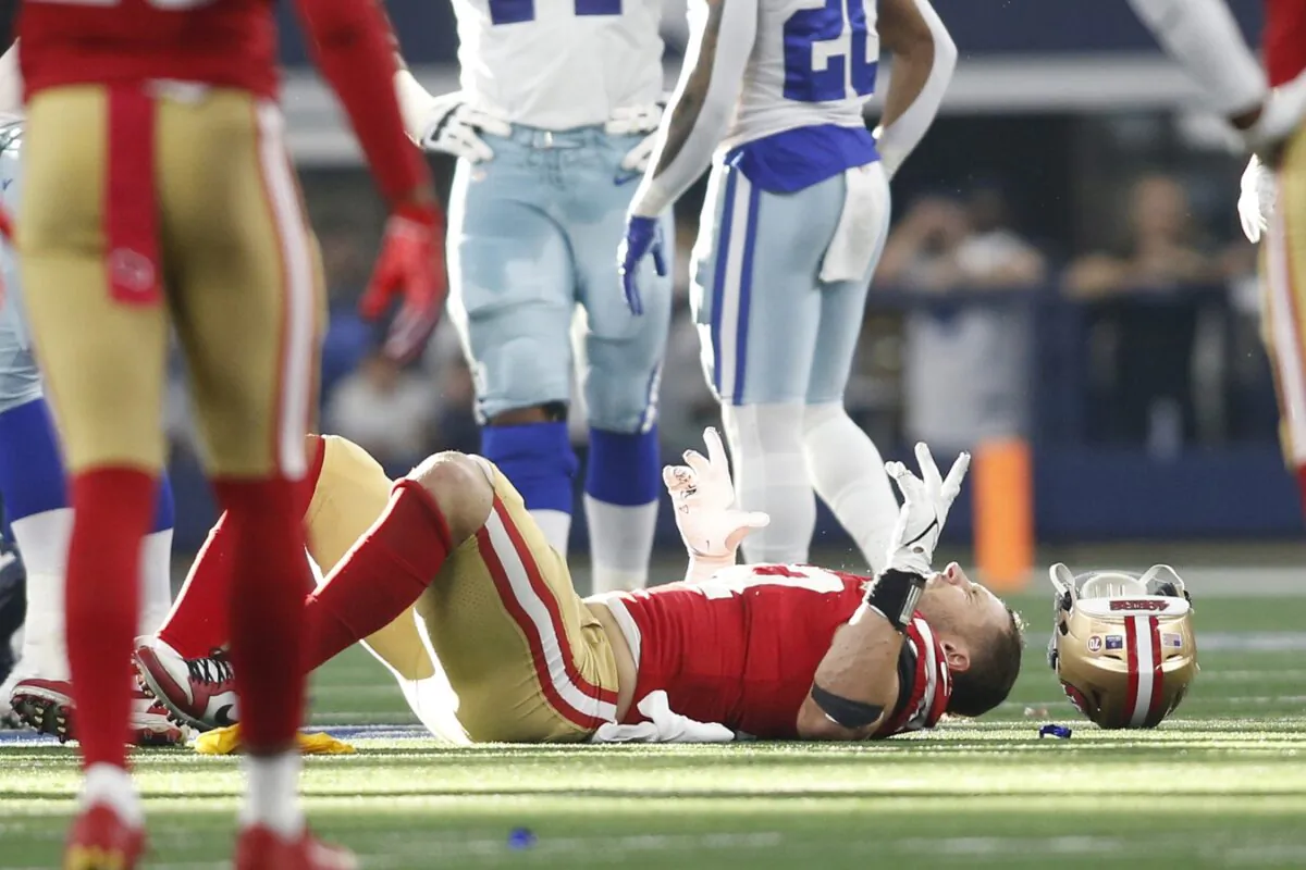 San Francisco 49ers defensive end Nick Bosa (97) lays on the field with an injury in the second quarter against the Dallas Cowboys in a NFC Wild Card playoff football game at AT&T Stadium on Jan 16, 2022 at Arlington, Texas. (Tim Heitman-USA TODAY Sports/via Field Level Media)
