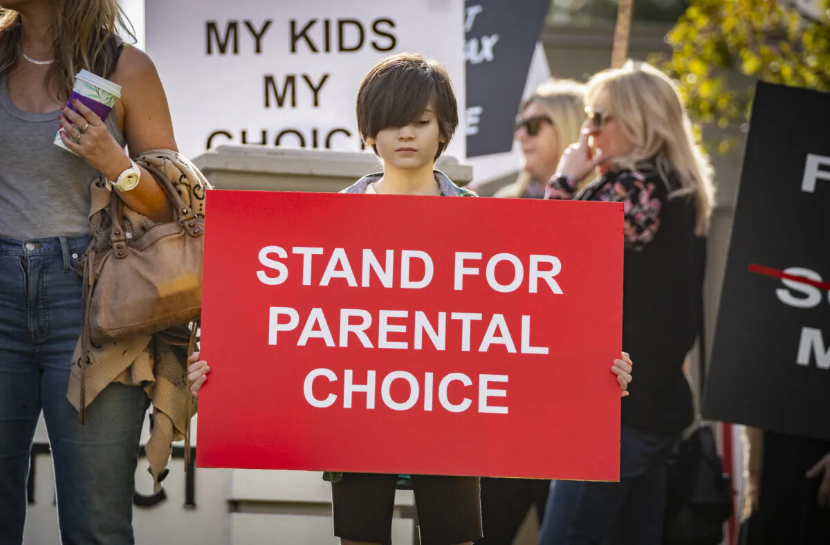 Parents and students gather in protest of school district policy's at the Placentia Yorba Linda Unified School District offices in Placentia, Calif., on Jan. 18, 2022. (John Fredricks/The Epoch Times)