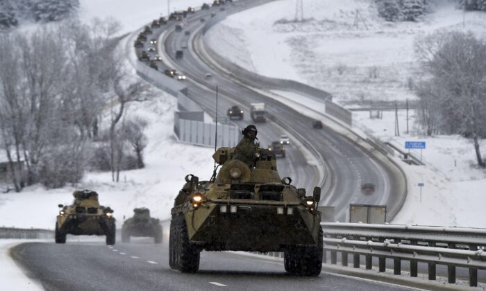 A convoy of Russian armored vehicles moves along a highway in Crimea, on Jan. 18, 2022. (AP Photo)