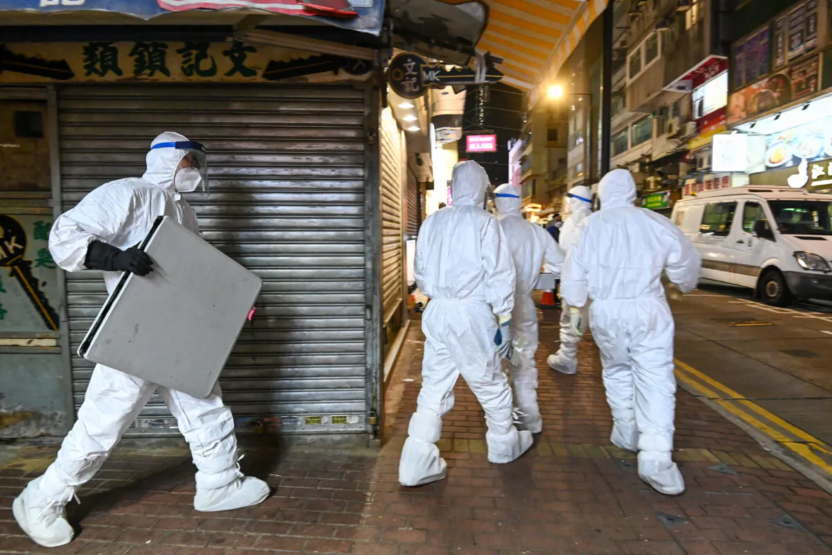 Hong Kong health officials enter a pet shop to cull pets and disinfect the store, in Causeway Bay, Hong Kong, on Jan. 18, 2022. (Sung Pilung/The Epoch Times)