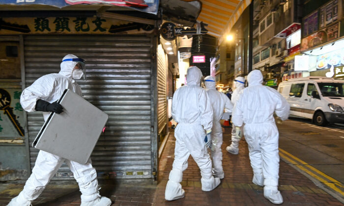 Hong Kong health officials enter a pet shop to cull pets and disinfect the store, in Causeway Bay, Hong Kong, on Jan. 18, 2022. (Sung Pilung/The Epoch Times) 