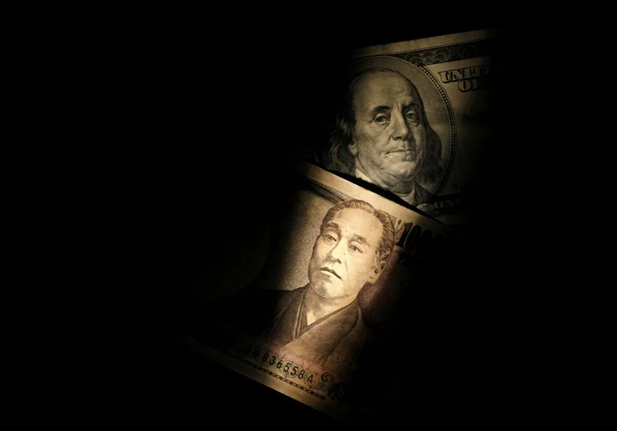 Light is cast on a U.S. one-hundred dollar bill next to a Japanese 10,000 yen note in this picture illustration shot on Feb. 28, 2013. (Shohei Miyano/Illustration/Reuters)