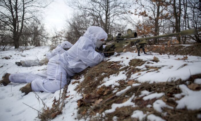 Snipers take part in military exercises at a firing ground of the Ukrainian armed forces in the Donetsk region, Ukraine, on Jan. 17, 2022. (Anna Kudriavtseva/Reuters)