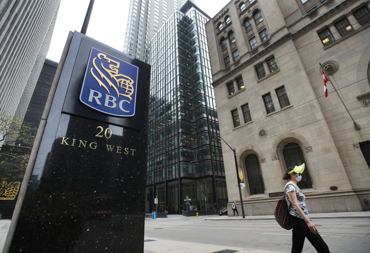 A person walks by the Royal Bank of Canada building in a file photo. (Nathan Denette/The Canadian Press)