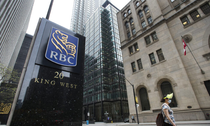 A person walks by the Royal Bank of Canada building on Bay Street in Toronto in a file photo. Canada’s central bank and financial regulator are preparing the country’s banks and insurance companies to deal with potential risks from the changing climate. (The Canadian Press/Nathan Denette)
