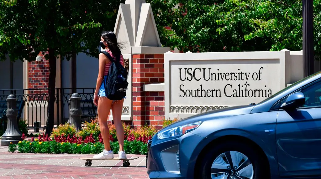 A student skateboards to campus at the University of Southern California in Los Angeles, Calif., on Aug. 25, 2020. (Frederic J. Brown/AFP via Getty Images)