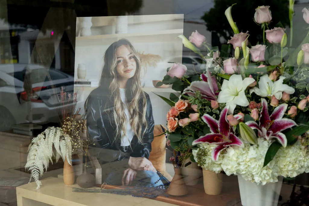 Flowers are placed outside Croft House furniture store in memory of graduate student Brianna Kupfer. Kupfer was stabbed to death by an unknown assailant while working in the store on January 13 in Los Angeles. (Emma McIntyre/Getty Images)