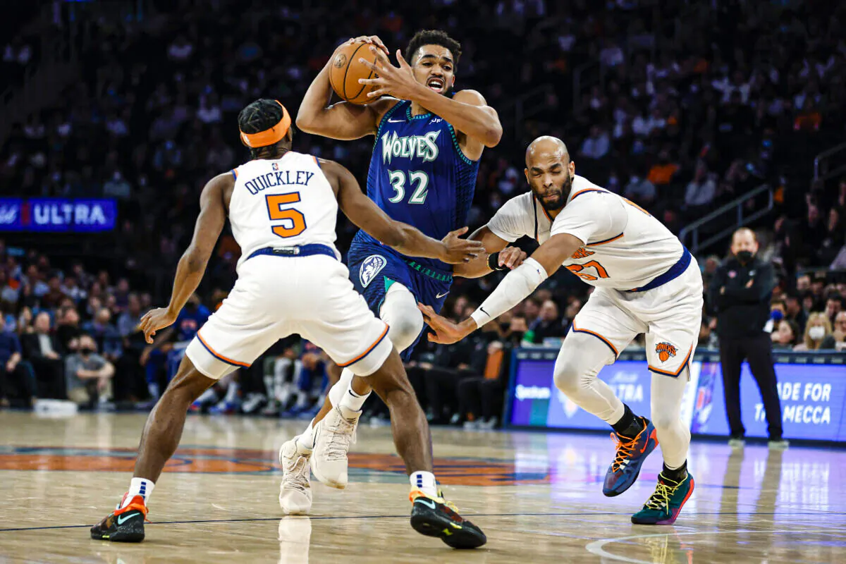 Karl-Anthony Towns #32 of the Minnesota Timberwolves dribbles as Immanuel Quickley #5 and Taj Gibson #67 of the New York Knicks defend during the first half at Madison Square Garden, in New York City, on January 18, 2022. (Sarah Stier/Getty Images)