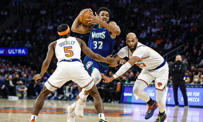 Karl-Anthony Towns #32 of the Minnesota Timberwolves dribbles as Immanuel Quickley #5 and Taj Gibson #67 of the New York Knicks defend during the first half at Madison Square Garden, in New York City, on January 18, 2022. (Sarah Stier/Getty Images)