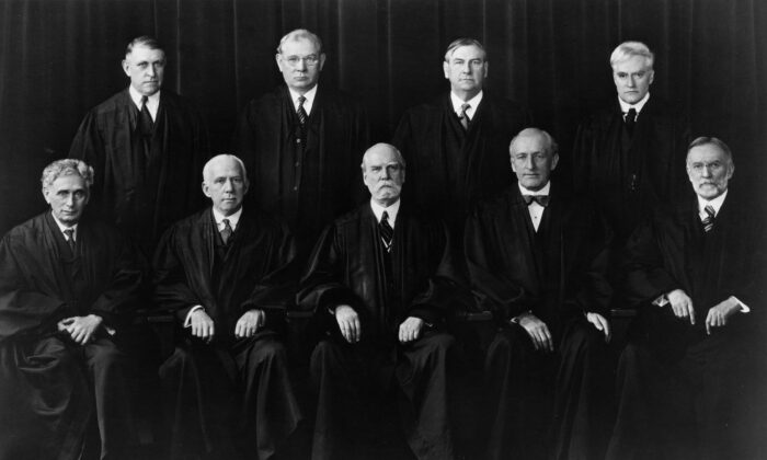 The members of the U.S. Supreme Court in 1937. Front row (L-R) Associate Justices Louis Brandeis and Willis Van Devanter; Chief Justice Charles Evans Hughes; Associate Justices James Clark McReynolds and George Sutherland. Back row (L-R) Associate Justices Owen Roberts, Pierce Butler, Harlan Fiske Stone, and Benjamin Cardozo. (MPI/Getty Images)