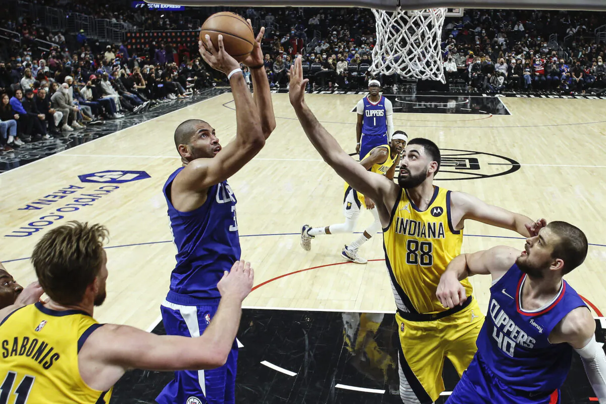 Los Angeles Clippers forward Nicolas Batum, second from left, shoots against Indiana Pacers center Goga Bitadze (88) during the second half of an NBA basketball game in Los Angeles on Jan. 17, 2022. The Clippers won 139-133. (Ringo H.W. Chiu/AP Photo)