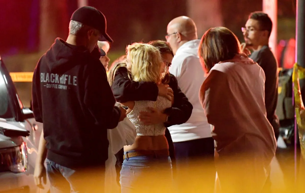 People comfort each other as they stand near the scene of a shooting in Thousand Oaks, Calif., on Nov. 8, 2018. (Mark J. Terrill/AP Photo)