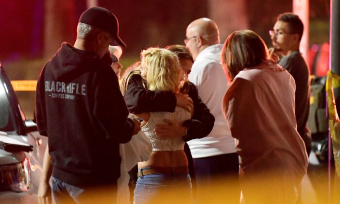 People comfort each other as they stand near the scene of a shooting in Thousand Oaks, Calif., on Nov. 8, 2018. (Mark J. Terrill/AP Photo)