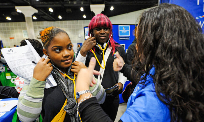 A transgender high school student (C) and classmate (L) visit the Children's Hospital Los Angeles booth during a college and career convention at the Los Angeles Convention Center in Los Angeles on December 8, 2010. (Kevork Djansezian/Getty Images)