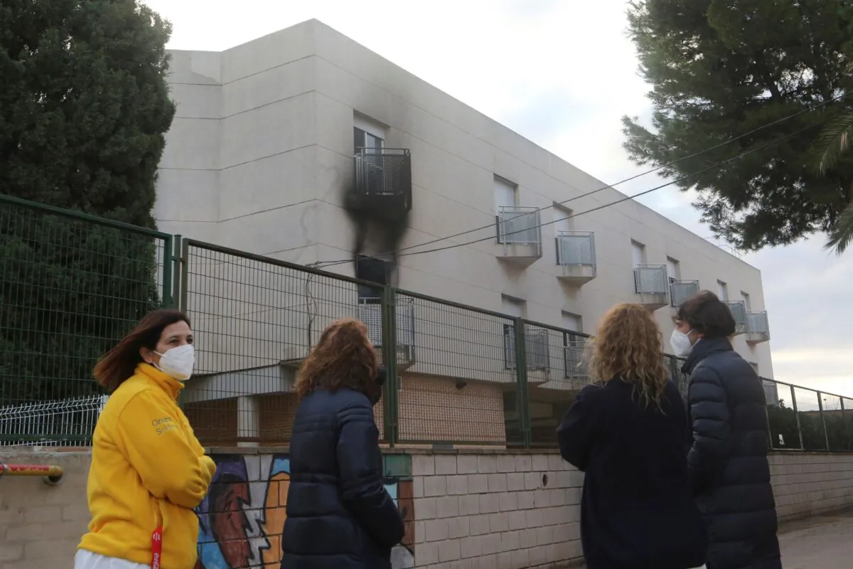 People look towards a nursing home after a fire in the municipality of Moncada just north of Valencia, Spain, on Jan. 19, 2022. (Alberto Saiz)