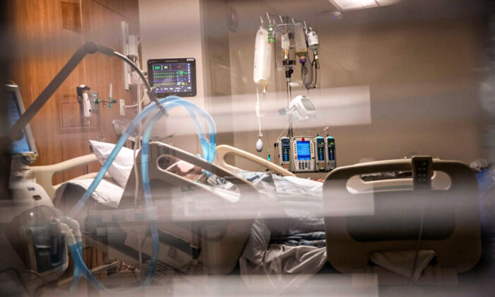 Breathing tubes hang next to a man with COVID-19 on a ventilator at a Stamford Hospital Intensive Care Unit in Stamford, Conn., on April 24, 2020. (John Moore/Getty Images)