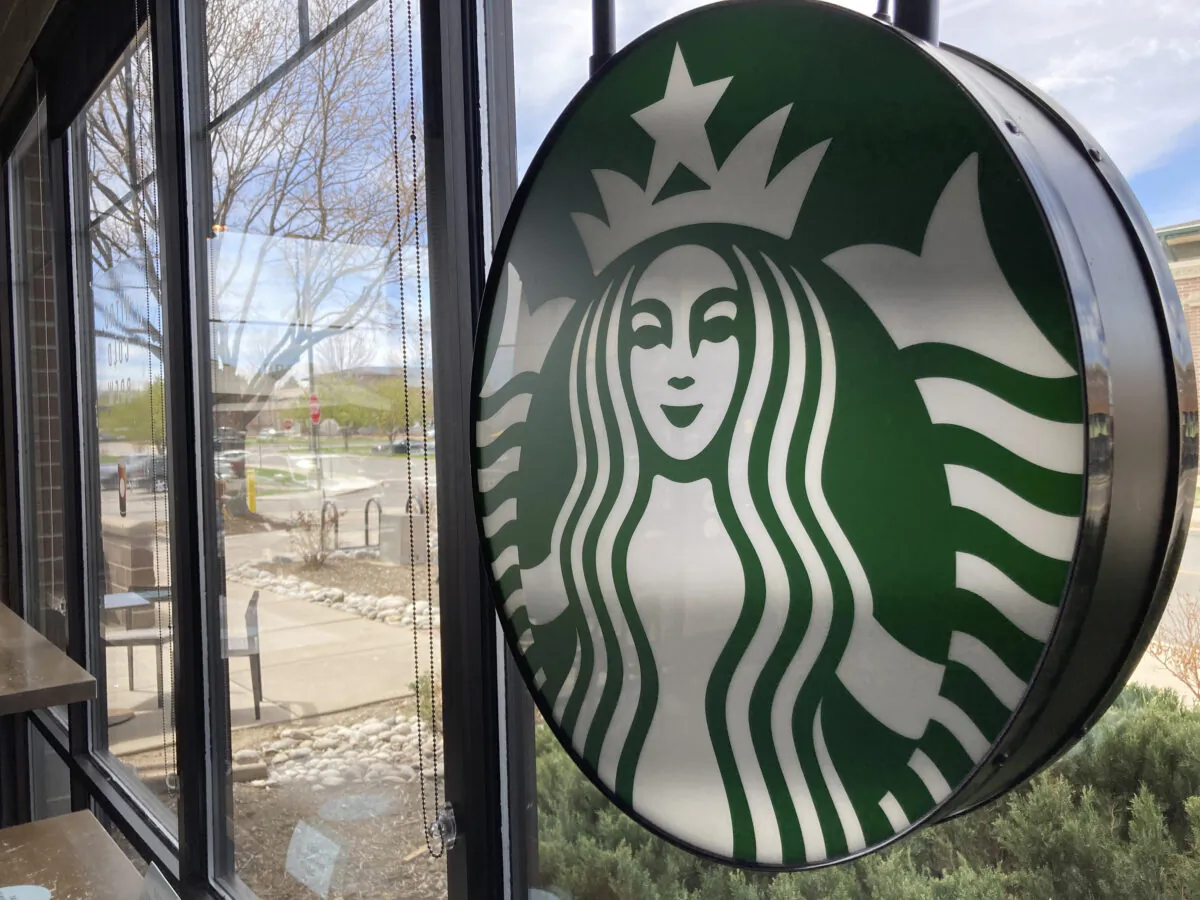 A sign bearing the corporate logo hangs in the window of a Starbucks in Denver, Colo., on April 26, 2021. (David Zalubowski/AP Photo)