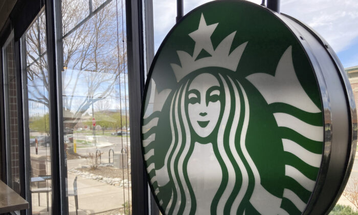 A sign bearing the corporate logo hangs in the window of a Starbucks in Denver, Colo., on April 26, 2021. (David Zalubowski/AP Photo)