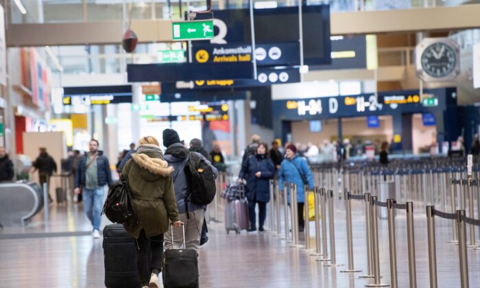 Travelers walk at Arlanda International Airport following the coronavirus concern and canceled flights, in Stockholm, Sweden, on March 12, 2020. (TT News Agency/Fredrik Sandberg via Reuters)
