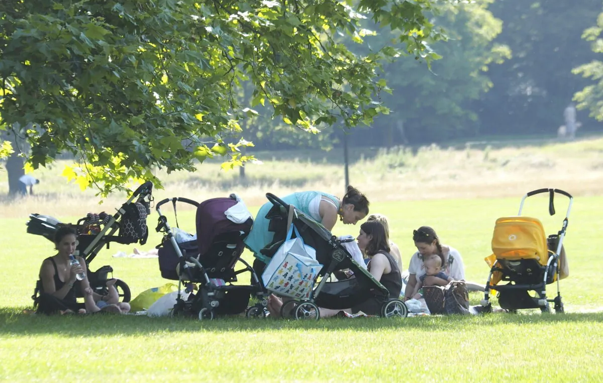 Undated file photo of women and children relaxing in a park. (Max Nash/PA)