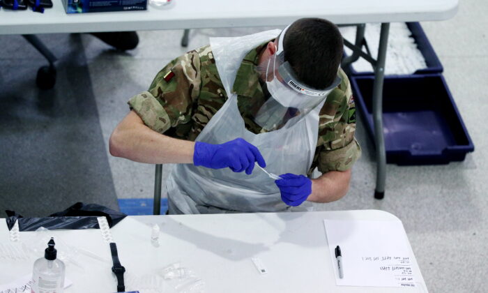 Undated file photo showing a soldier carrying out COVID-19 testing. (Peter Byrne/PA)