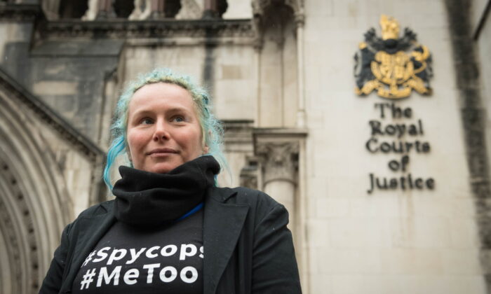 Environmental activist Kate Wilson, who was deceived into a nearly two-year relationship with an undercover officer, and has won a landmark tribunal case against the Metropolitan Police for breaches of her human rights, poses for photos outside the Royal Courts of Justice in London on Feb. 27, 2020. (Stefan Rousseau/PA)