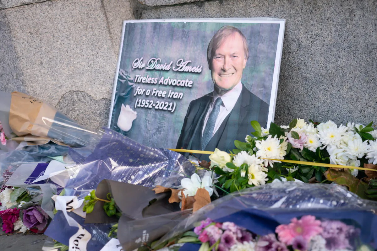 Flowers left in memory of Sir David Amess outside the Houses of Parliament, in Westminster, London, on Oct. 22, 2021. (Dominic Lipinski/PA)