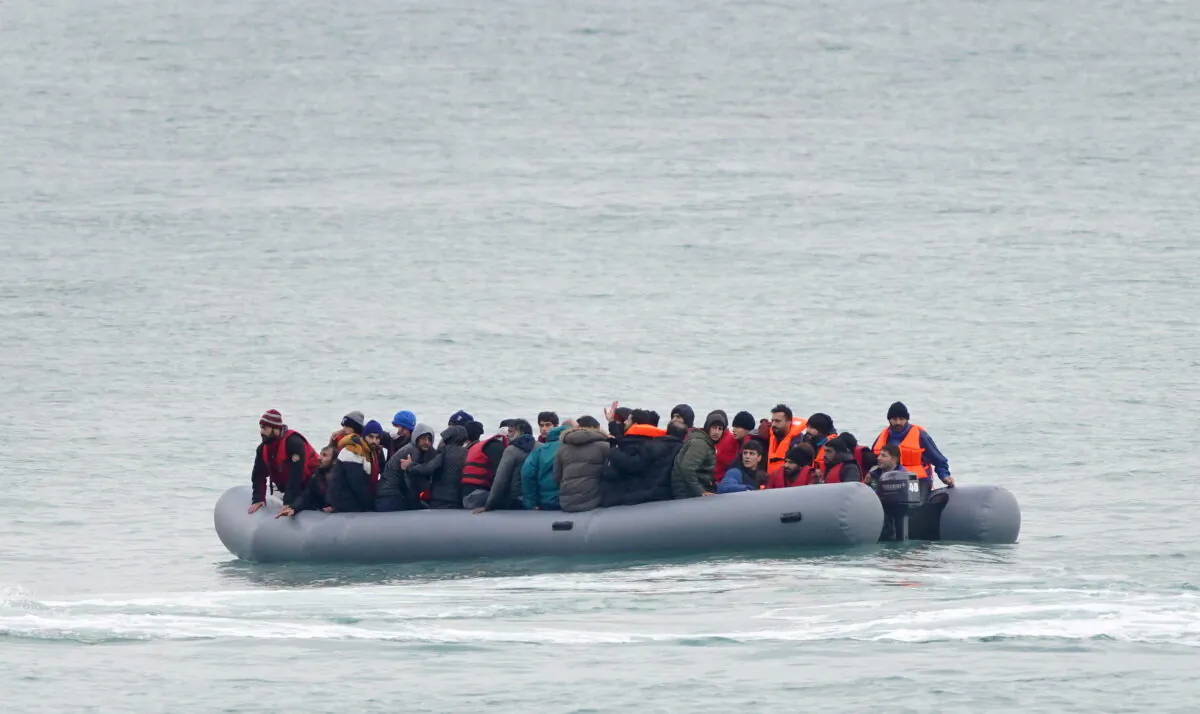 Undated file photo showing a group of people adrift in a dinghy before being rescued off the coast of Folkestone, Kent, England. (Gareth Fuller/PA)