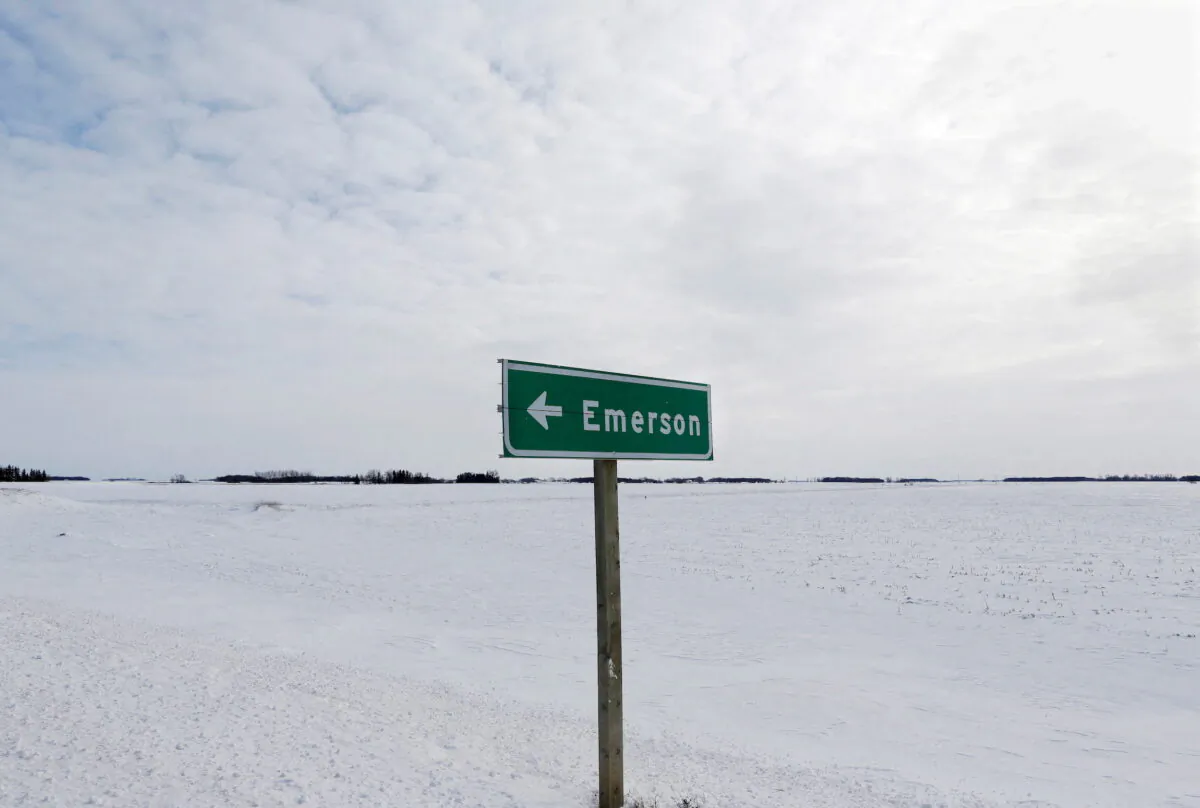 A sign post for the small border town of Emerson, near the Canada-US border crossing in Emerson, Manitoba, Canada, on Feb. 1, 2017. (Lyle Stafford/Reuters)