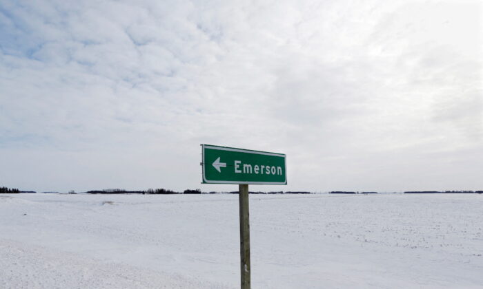 A sign post for the small border town of Emerson, near the Canada-US border crossing in Emerson, Manitoba, Canada, on Feb. 1, 2017. (Lyle Stafford/Reuters)