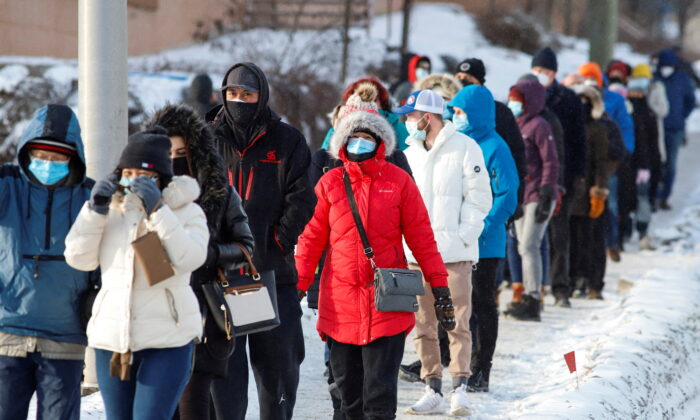 People queue to collect coronavirus disease (COVID-19) antigen test kits at the Hazeldean Mall in Ottawa, Ontario, Canada on Jan. 7, 2022. (Patrick Doyle/Reuters)