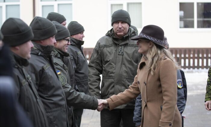 In this photo provided by Ukrainian National Guard Press Office Canada’s Minister of Foreign Affairs Melanie Joly, right, greets Ukrainian soldiers during her visit to the National Guard base close to Kyiv, Ukraine, on Jan. 18, 2022. (The Canadian Press/AP-Ukrainian National Guard Press Office via AP)