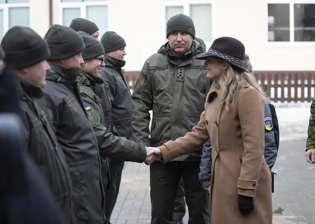 In this photo provided by Ukrainian National Guard Press Office Canada’s Minister of Foreign Affairs Melanie Joly, right, greets Ukrainian soldiers during her visit to the National Guard base close to Kyiv, Ukraine, Jan. 18, 2022. (The Canadian Press/AP-Ukrainian National Guard Press Office via AP)