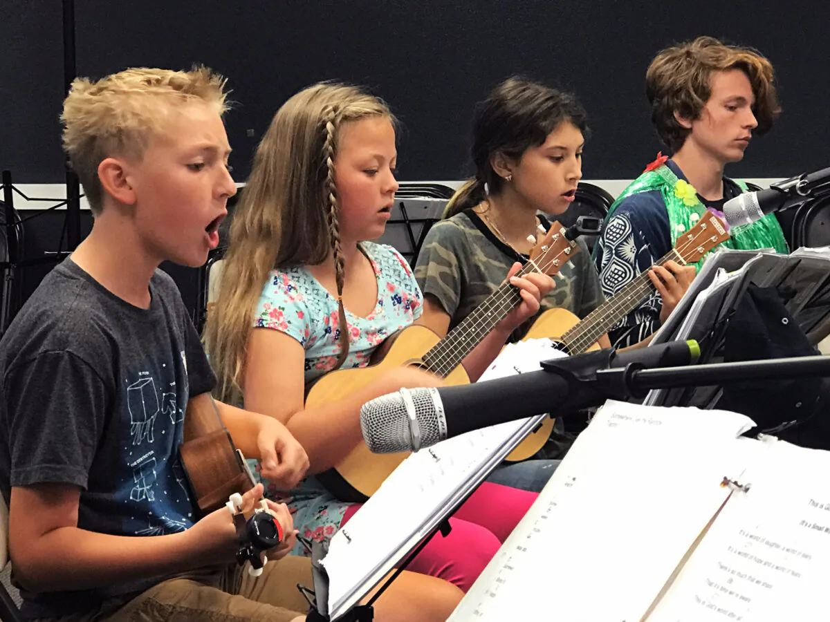 Intermediate students play at the Parents Progress Recital at Musical Mentors in San Clemente, Calif., in 2019. Maki (R) is the volunteer mentor for this group, having gone through the entire program himself. (Courtesy of Duff Rowden)