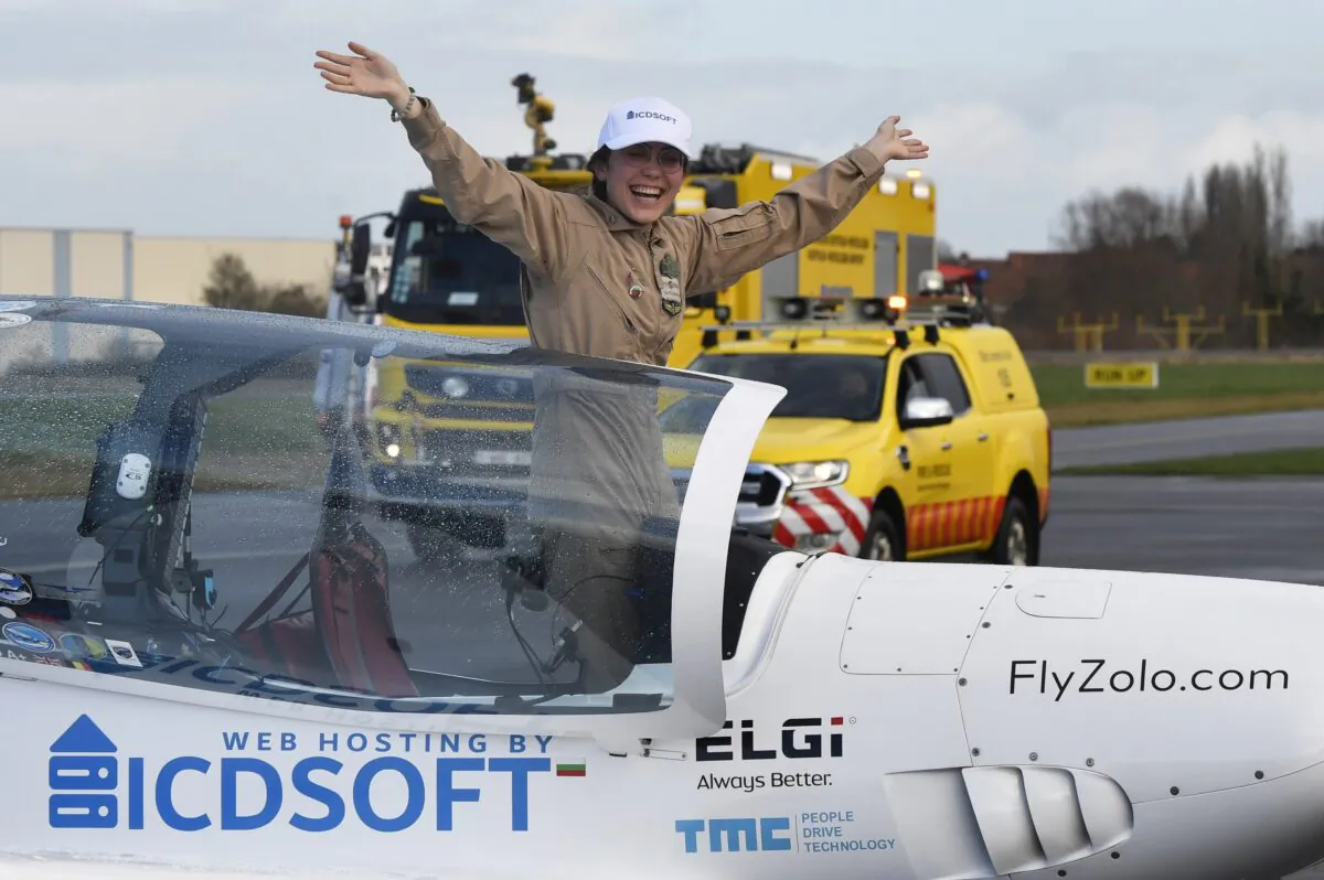 Belgium-British teenage pilot Zara Rutherford jubilates in the cockpit, after landing her Shark ultralight plane at the Kortrijk airport in Kortrijk, Belgium, on Jan. 20, 2022. (Geert Vanden Wijngaert/AP Photo)