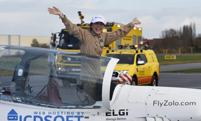 Belgium-British teenage pilot Zara Rutherford jubilates in the cockpit, after landing her Shark ultralight plane at the Kortrijk airport in Kortrijk, Belgium, on Jan. 20, 2022. (Geert Vanden Wijngaert/AP Photo)