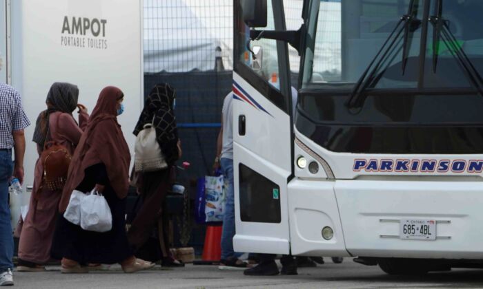 Refugees from Afghanistan board a bus after being processed at Pearson Airport in Toronto, Aug 17, 2021. (The Canadian Press/Sean Kilpatrick)