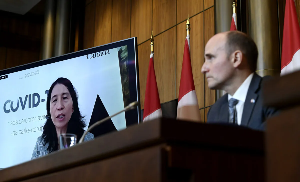 Canada's Chief Public Health Officer Dr. Theresa Tam is seen via videoconference as Health Minister Jean-Yves Duclos looks on during a news conference on the COVID-19 pandemic, in Ottawa on Jan. 7, 2022. (Justin Tang/The Canadian Press)
