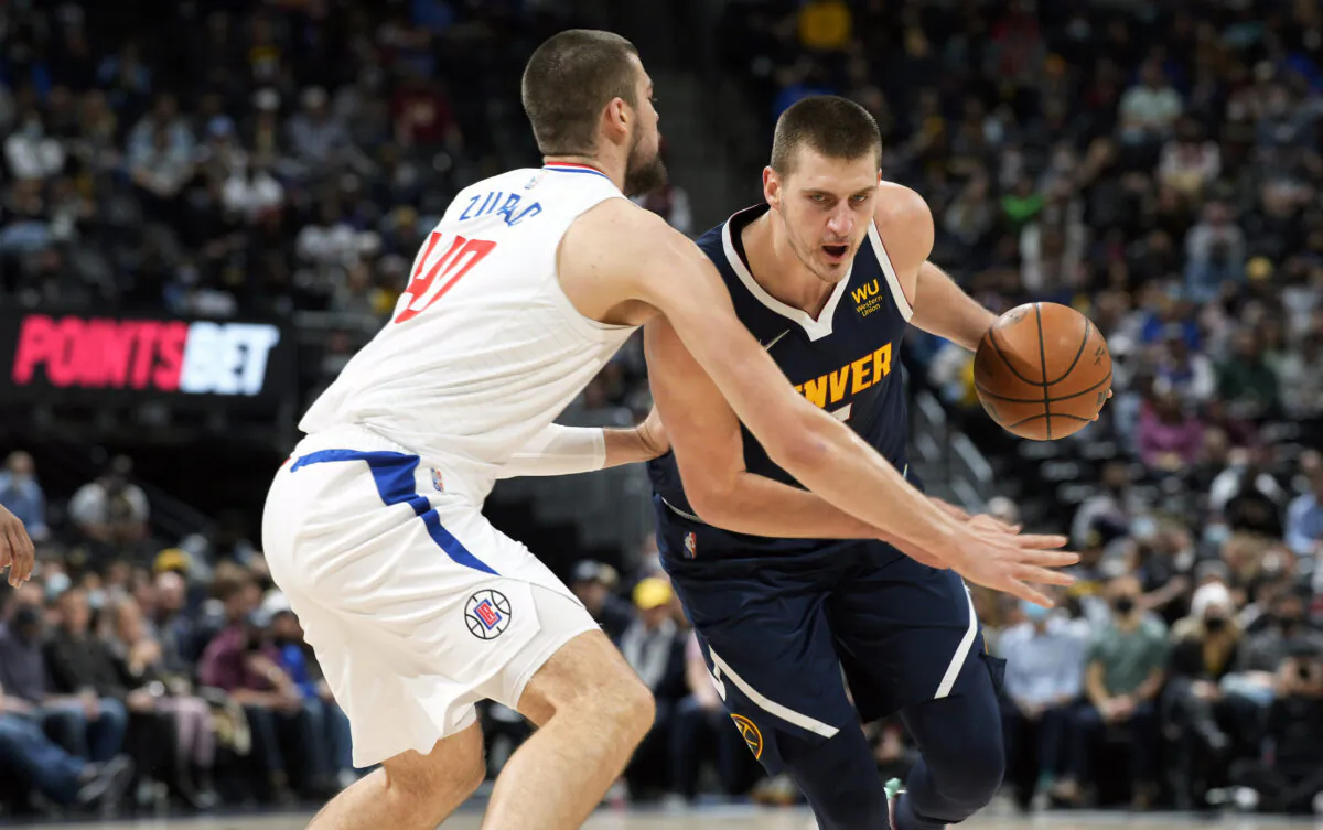 Denver Nuggets center Nikola Jokic, right, drives the lane as Los Angeles Clippers center Ivica Zubac defends in the first half of an NBA basketball game in Denver on Jan. 19, 2022. (David Zalubowski/AP Photo)