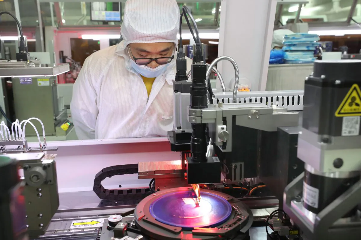 An employee observes chip production at a factory in Nantong in eastern China's Jiangsu Province, on March 17, 2021. (STR/AFP via Getty Images)