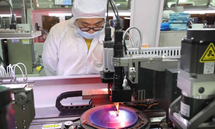 An employee makes chips at a factory of Jiejie Semiconductor Company in Nantong, in eastern China's Jiangsu Province on March 17, 2021. (STR/AFP via Getty Images)