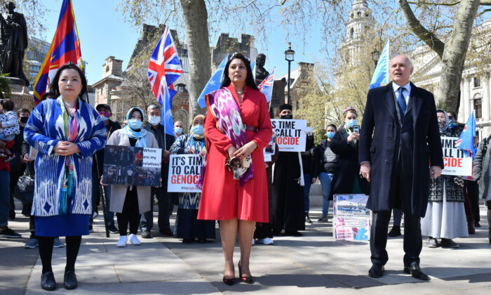British Conservative Party MPs Nusrat Ghani (C), Sir Iain Duncan Smith (R), and UK director of the World Uyghur Congress UK Director Rahima Mahmut at a demonstration call on the British Parliament to vote to recognise alleged persecution of China's Muslim minority Uyghur people as genocide and crimes against humanity in London on April 22, 2021. (Justin Tallis/AFP via Getty Images)