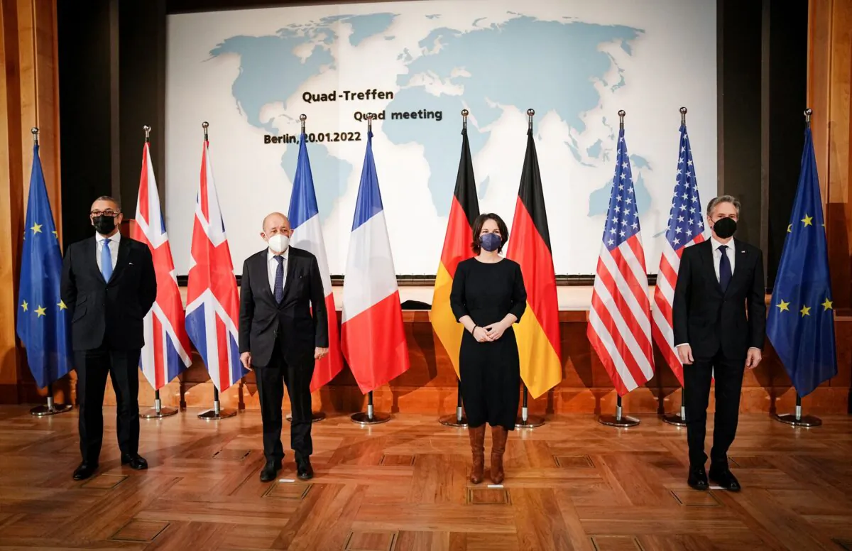 French Foreign Minister Jean-Yves Le Drian, is seated with the French delegation for a meeting with U.S. Secretary of State Antony Blinken, German Foreign Minister Annalena Baerbock, and British Minister of State for Middle East, North Africa and North America James Cleverly, at the Ministry of Foreign Affairs in Berlin, Germany on Jan. 20, 2022. (Alex Brandon/Pool via Reuters)