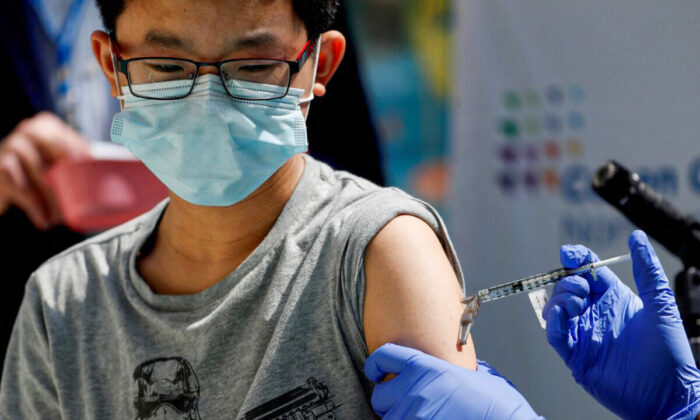 A 13-year-old boy gets the Pfizer-BioNTech COVID-19 vaccine at a medical center in New Hyde Park, N.Y., on May 13, 2021. (Shannon Stapleton/Reuters)