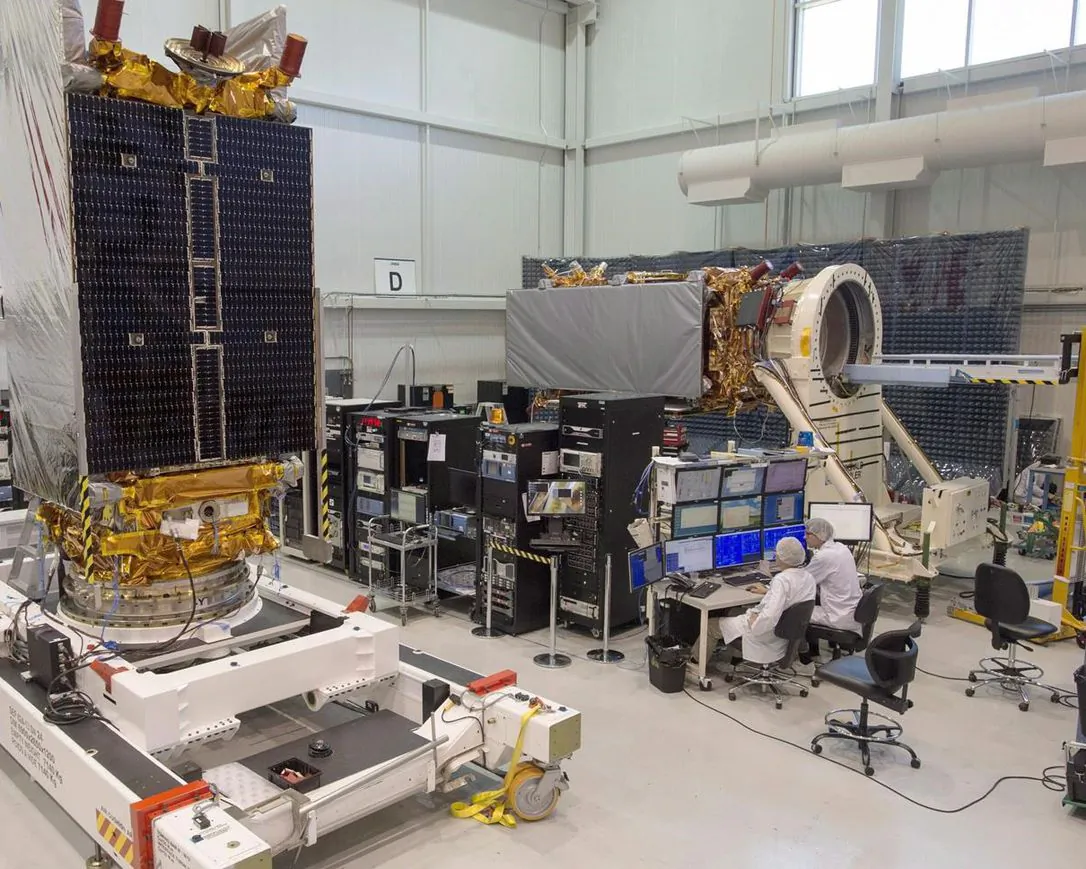 Technicians put the final touches on two of three Radarsat Constellation Mission satellites at the MDA facility, June 21, 2018 in Montreal. (The Canadian Press/Ryan Remiorz)